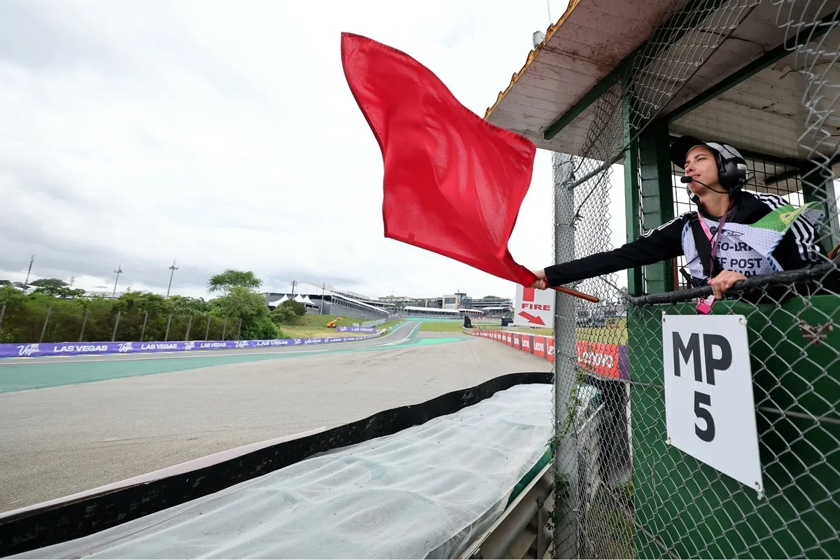 A marshal waves the red flag